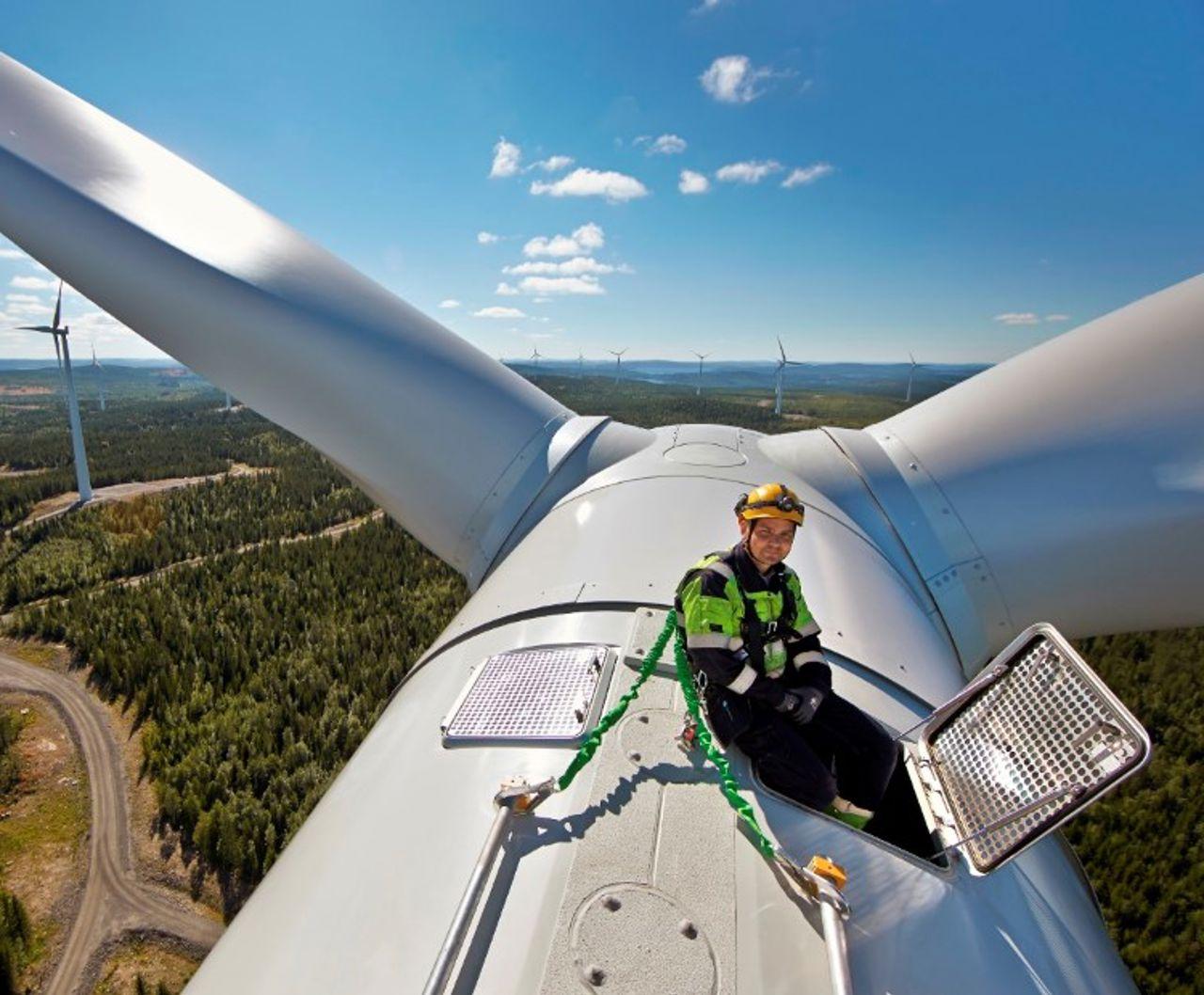 Man on the top of a wind turbine